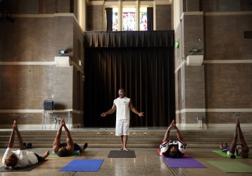 Marshawn Feltus leads an ACT Yoga class